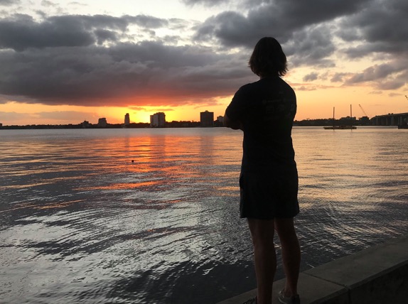Jaacob Bowden looks at the dolphins during sunset at Jim Rink Park in Jacksonville, Florida.