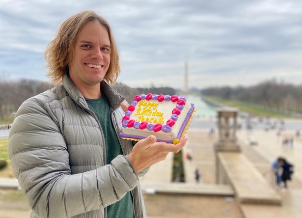Jaacob Bowden holds his birthday cake on the steps of the Lincoln Memorial
